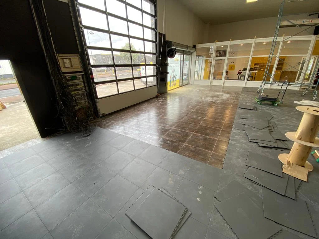 ULTIMA JOINTS INVISIBLES slabs are currently being installed over the sanded tile floor at Brie Auto Services