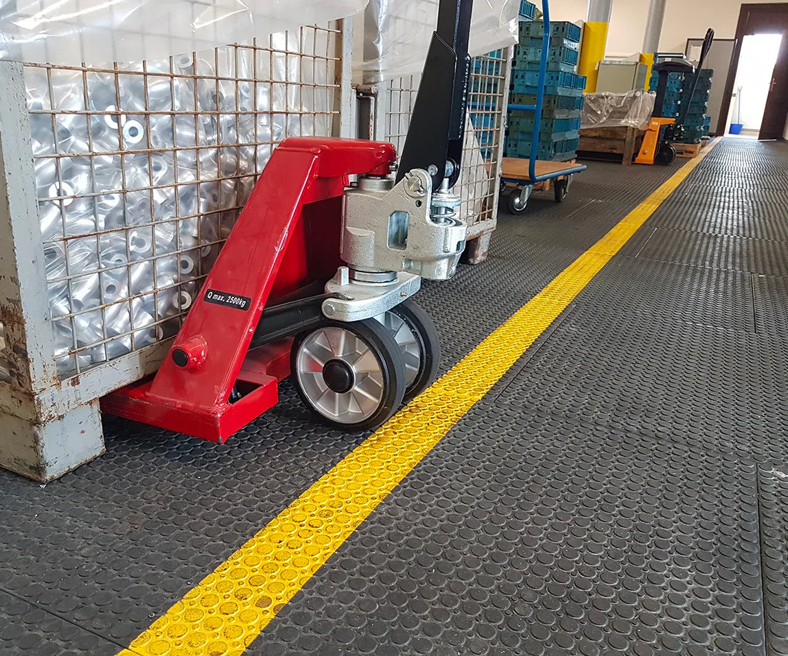 Hiolle Technologies: Pallet jack loaded onto MOSAIK INTENSE slabs, aisle marked with yellow paint