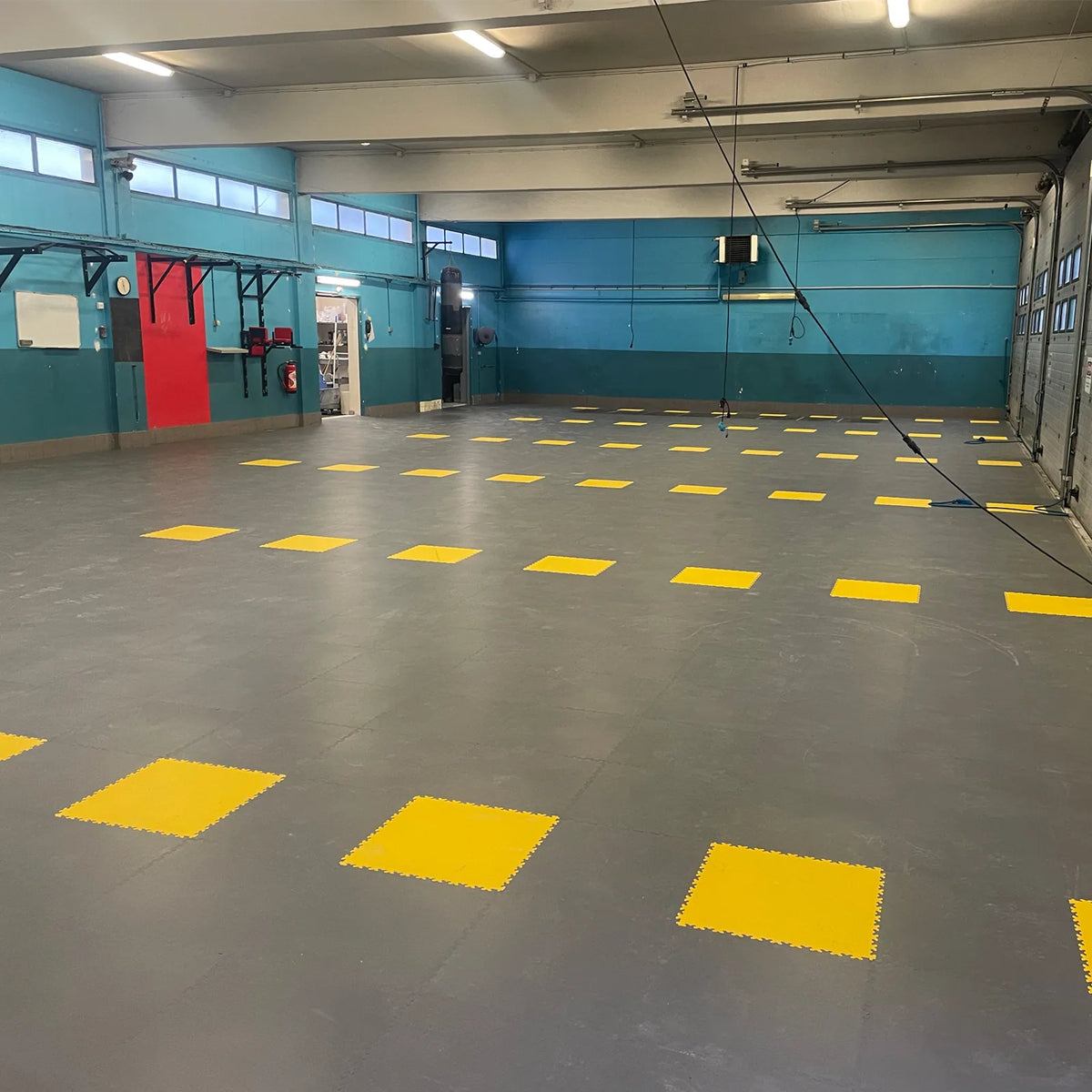 Remise de la caserne SDIS 95 après pose : dalles PVC ULTIMA ULTRA PURE gris foncé collées avec repères jaunes